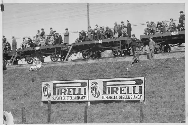 PIRELLI STELLA BIANCA sign at the Finnish Grand Prix in 1937. Spectators are seen watching the race from a rail car temporarily converted into grandstands.